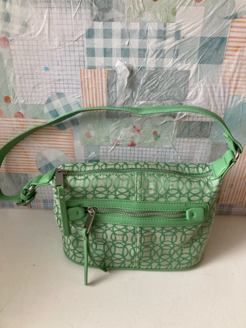 Green Patterned Shoulder Bag 23in strap. Silver hardware with zipper closing